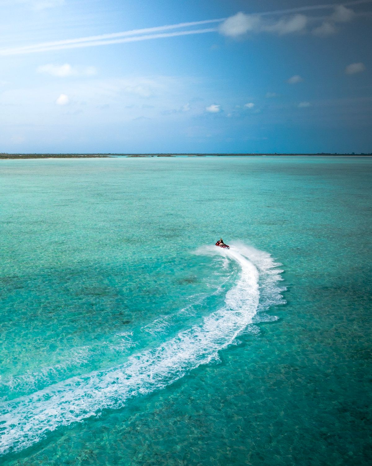 Rider standing on a jet ski cruising through Diani waters