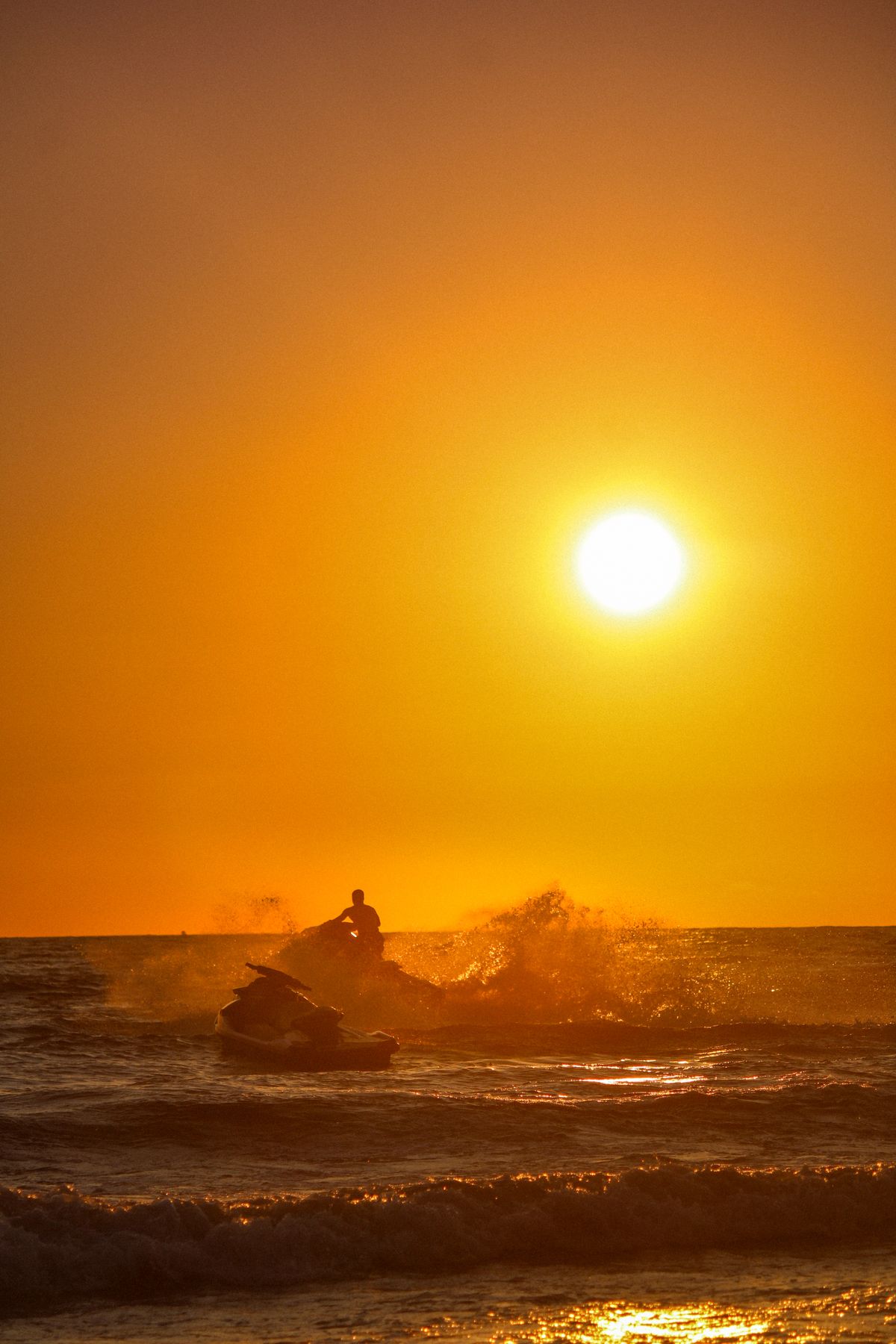 Jet skis gathered on a sandbar during a Diani water sports tour