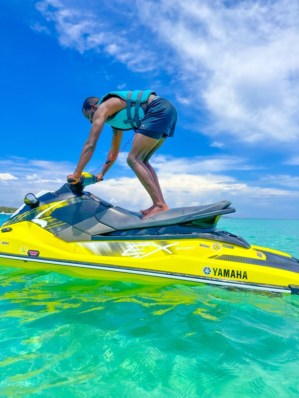 Two jet skis parked on the shallow turquoise waters of Diani Beach